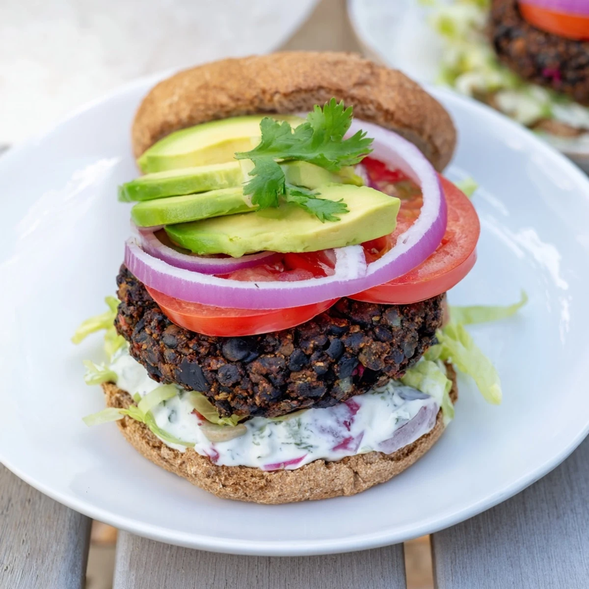 A close-up shot of grilled Zesty Black Bean Burgers reveals vibrant colors and fresh toppings.