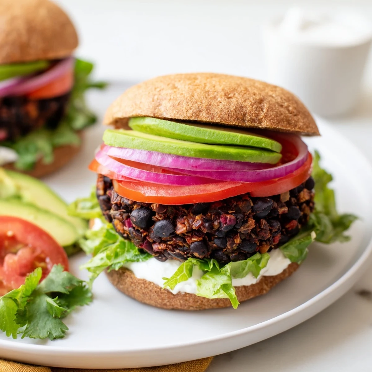Delicious Zesty Black Bean Burgers with avocado slices, a healthy and easy weeknight meal idea.