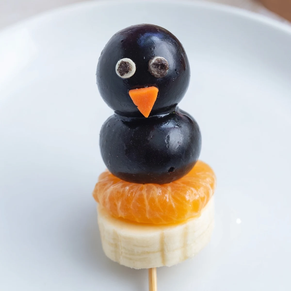 Adorable Penguin Fruit Skewer Army featuring juicy grapes, strawberries, and fun blueberry heads.