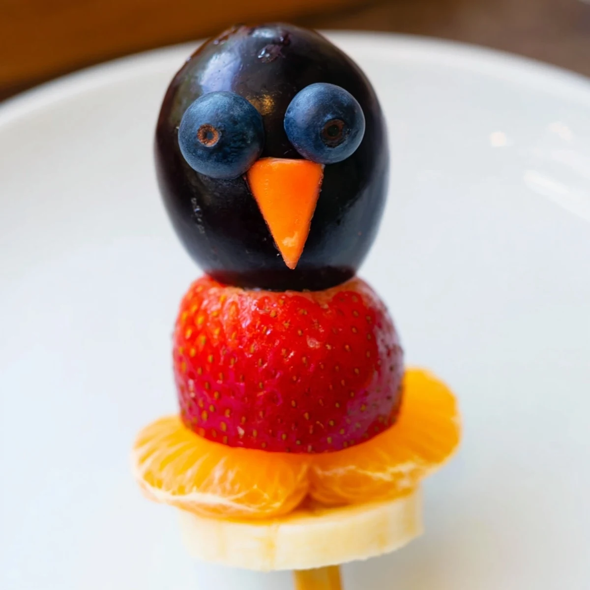 Bright and colorful Penguin Fruit Skewer Army, a refreshing and easy kids' snack idea.