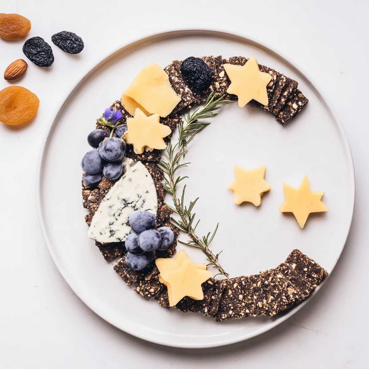 Appetizing Crescent Moon & Stars Cheese Board, featuring assorted cheeses, crackers, grapes, and almonds; ideal for gatherings.