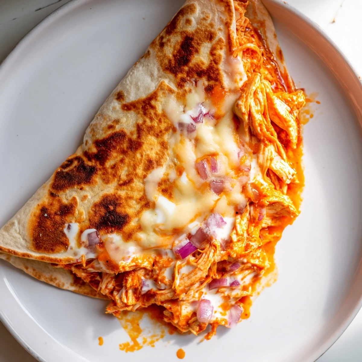 Golden, crispy Buffalo Chicken Quesadilla, filled with melted cheese and spicy, tender chicken, ready to serve.