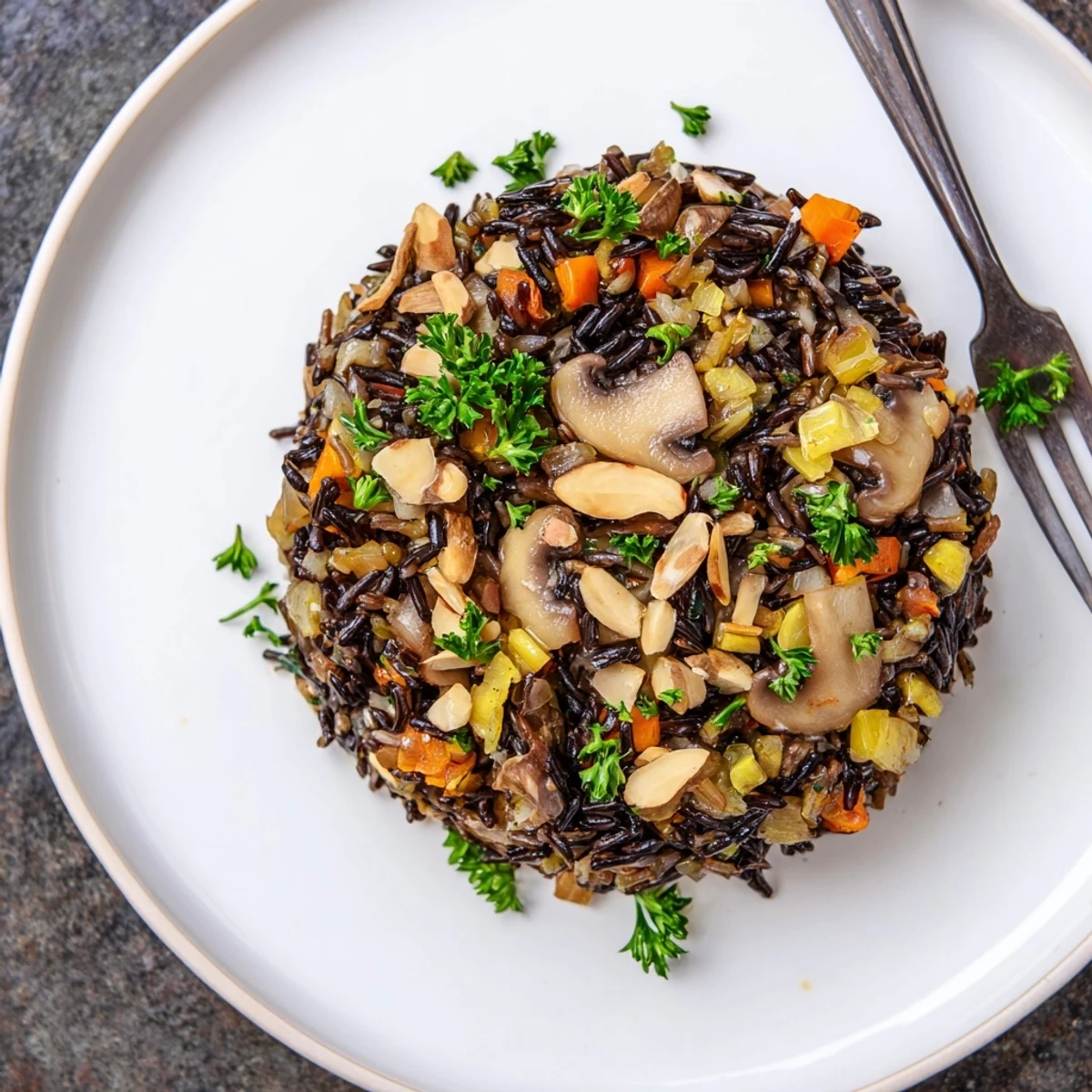 Fluffy Wild Rice and Mushroom Pilaf topped with parsley, a gluten-free vegetarian side dish for dinner.
