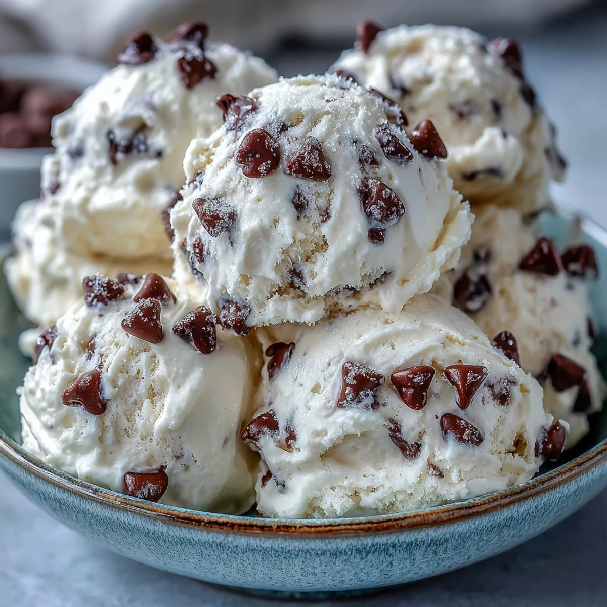 Creamy Greek Yogurt Cookie Dough scoops, featuring melted chocolate chips and a smooth, chilled texture ready to eat.