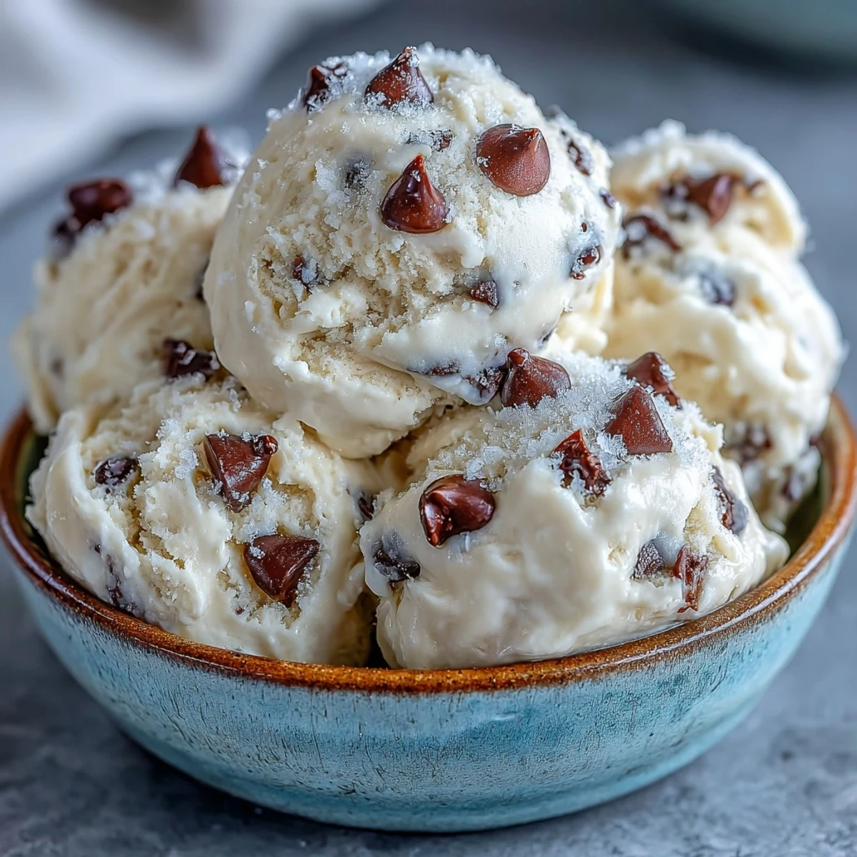 Spoon holding a scoopable bite of Greek Yogurt Cookie Dough, highlighting its egg-free, rich, and tangy dessert quality.