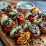 Smoky, tender grilled veggie kabobs loaded with fresh produce, ready to serve with chimichurri.