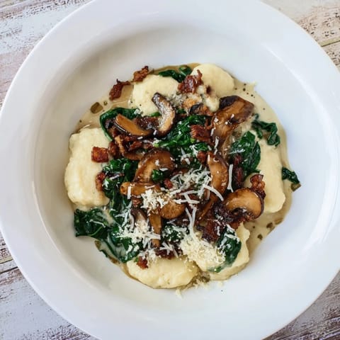 A steaming skillet of comforting Woodsy Skillet Sausage and Mushroom Gnocchi awaits, filled with earthy mushrooms and savory sausage.