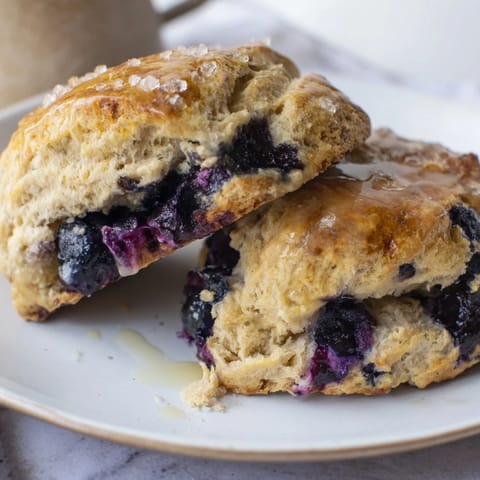 Golden, warm Rustic Birch-Warm Blueberry Scones, bursting with syrupy blueberries, perfect for a comfort breakfast.