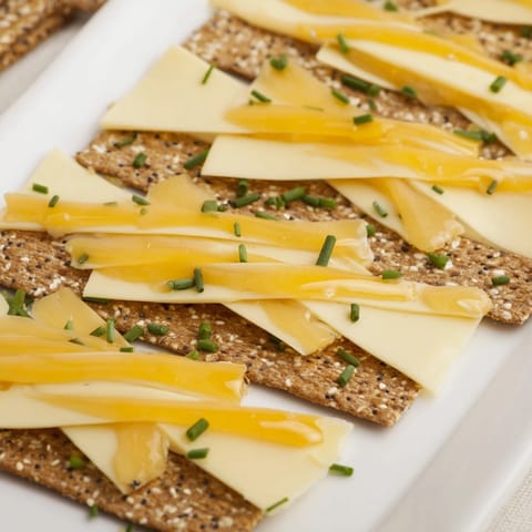 Image of a beautifully constructed Garden Gate Lattice appetizer: a vibrant lattice of cheeses and crackers.