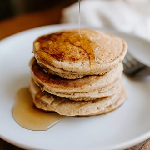 Golden-brown Protein Power Pancakes sizzling on a griddle, ready to flip for a quick, high-protein breakfast.