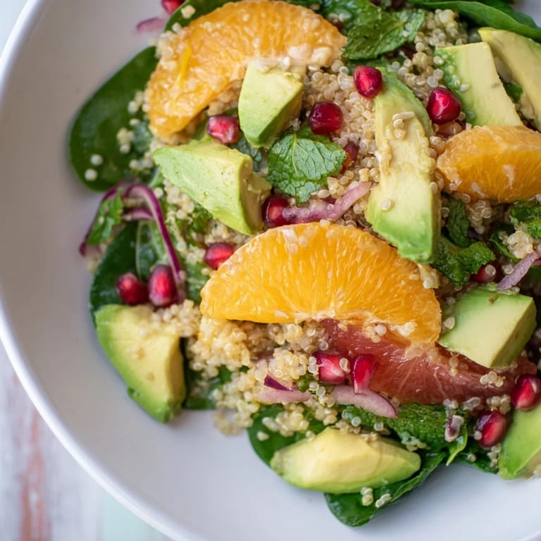 A healthy fresh citrus & avocado quinoa bowl overflowing with colorful, flavorful ingredients, ready to enjoy.