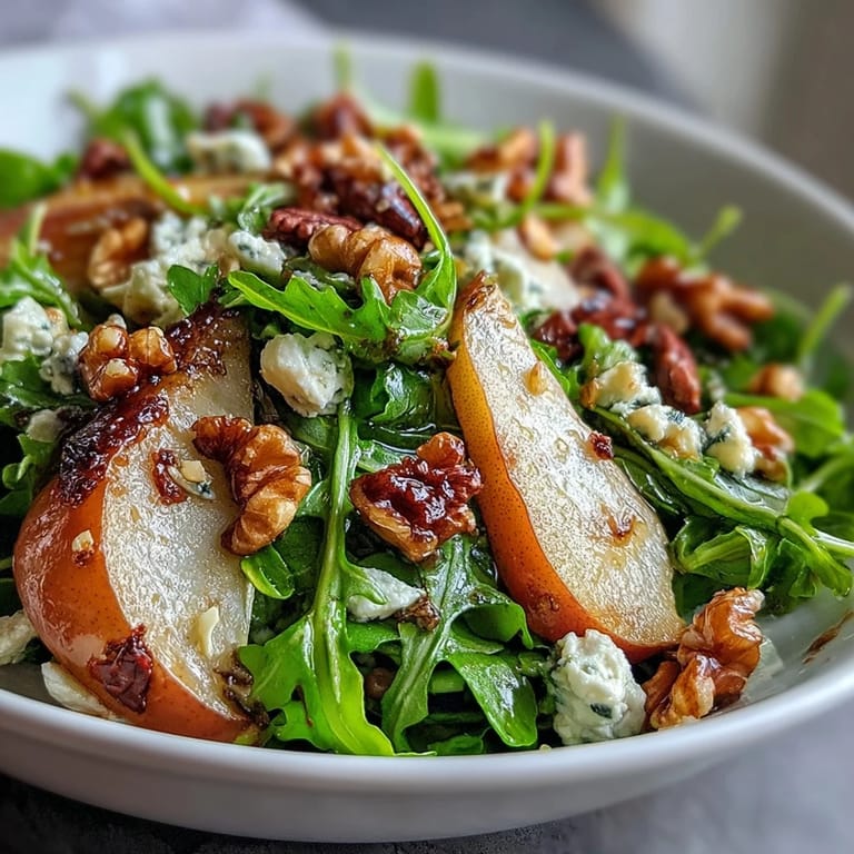 Arugula and Pear Bowl with sliced ripe pears, creamy cheese, and honey-balsamic dressing drizzled over greens. 
